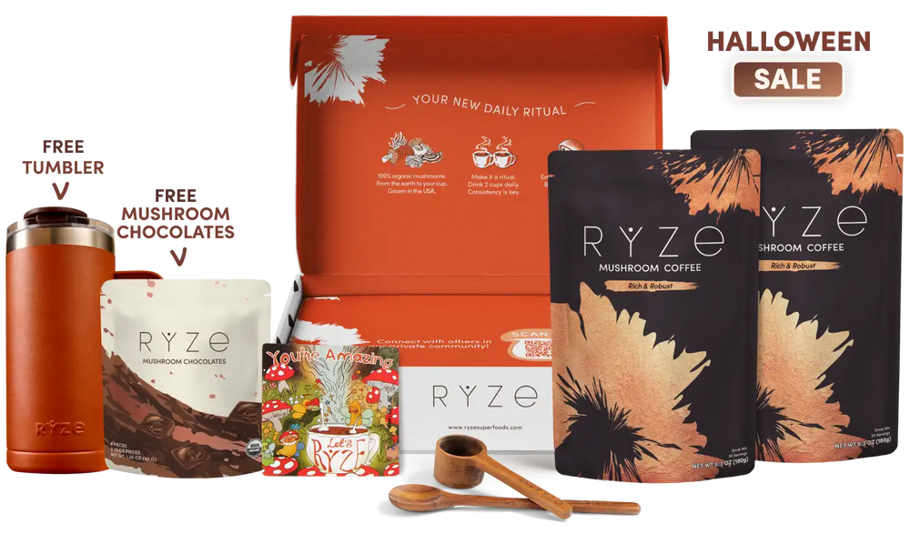Ryze Mushroom Coffee gift set displayed on a white background with promotional text. The set includes an orange gift box, two black and orange pouches of Ryze Mushroom Coffee, a free tumbler, free mushroom chocolates, a wooden scoop, and two wooden spoons.